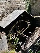 Photograph of the water wheel of Chez Lyonnet mill in operation.