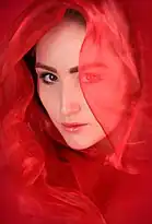 Woman posed with a red veil
