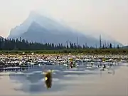 Mount Rundle through the haze of wildfire smoke, as seen from the middle of Vermilion Lake one