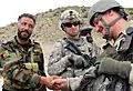 A Macedonian Soldier shakes hands with an Afghan National Army Soldier.