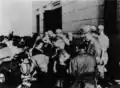 Victims receiving relief works in front of Hiroshima Credit Union HQ on 7 August 1945