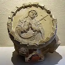 Photograph of a keystone showing a Virgin with a heart pierced by a sword.