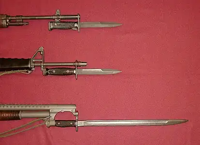 U.S. military bayonets of the Vietnam War. Top: M6 Bayonet affixed to the M14 Rifle. Center: M7 Bayonet affixed to the M16A1 Rifle. Bottom: M1917 Bayonet affixed to the Winchester Model 12 Combat Shotgun.
