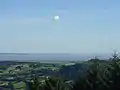 View from Twmbarlwm over the Bristol Channel towards England. Brean Down is in the centre of the photo. Weston-super-Mare is out of sight in the bay to the left of Brean Down.