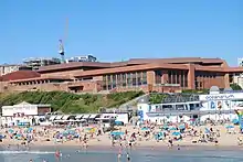 A large conference centre, situated behind a beach