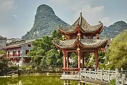 View from a garden in Huangyao with a pavilion in the foreground and a hill in the background