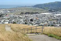 View southeast to Visitacion Valley and Brisbane from Visitacion Ave and Mansell Street in John McLaren Park. The stairs lead to Wilde Avenue.