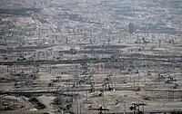 The densely developed Kern River Oil Field, California: Hundreds of pumpjacks are visible in the full-size view. This style of development was common in the oil booms of the early 20th century.