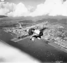 A Vickers Vildebeest Mk III of No. 36 Squadron RAF in flight over Singapore City.