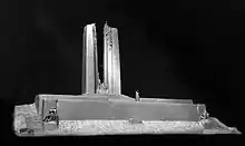 A white plaster design model of the Vimy Memorial from the front side, displayed against a black background