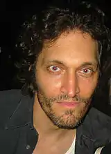 Photograph of Vincent Gallo, peering into the camera lens with an intense and soulful gaze