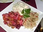 Kyrgyz-Kazakh starters served at a restaurant in the United Kingdom. Clockwise from left: vinegret, olivier salad, and funchoza (2009)
