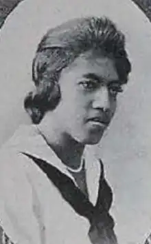 A young Black woman wearing a sailor-style middy blouse