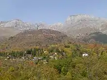 Village in autumn, with mountains in background