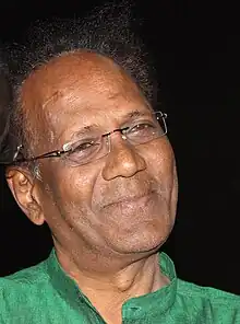 Close-up photo of the face of Indian actor Virendra Saxena, March 2015