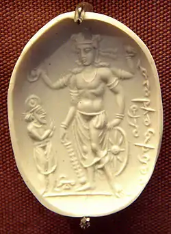 The Vishnu Nicolo Seal may depict Vāsudeva, holding the attributes of the gada club, the chakra discus, the wheel and the lotus, rather than Vishnu. 4th century CE, Gandhara.