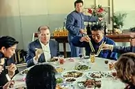 A meal being eaten during a state visit of Hungary to China inside a people's commune during meal hour.