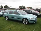 Passenger side view of a seafoam green pre-facelift V70 R