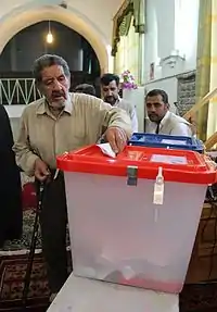 A man in Sarakhs put his vote to ballot, 2013 Iranian presidential election.