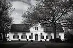 The farm Vredenburg was granted to Hendrik Elbertz in 1691. The historic dwelling thereon was built by a later owner, Jacob Roux, in 1789.