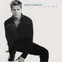 A black-and-white photo of Martin in fully black outfits, while sitting on the floor. Also, his name and the album's title are written in seafoam green color on the top left.