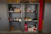 Stationery cupboard: An office stationery cupboard, with its lockable doors open