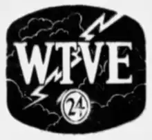A superellipse with a television screen shape in black. Faint white lines suggest clouds. A white lightning bolt strikes from the upper right. Superimposed in white with a black stroke are the letters WTVE in a condensed bold serif. In the bottom, a white circle with a black trim ring includes the number 24, also in a serif.