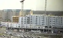 A wide apartment building under construction