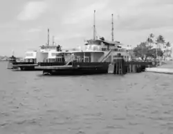 Two large ferries docked on an island on a clear day