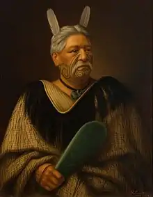 A portrait of Wahanui Reihana Te Huatare carrying a mere and wearing a hei-tiki made of pounamu