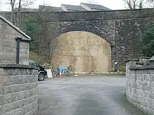 A large stone bridge in a deep cutting that has been walled up in the portal
