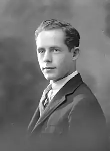 Posed photograph of a young man wearing a suit
