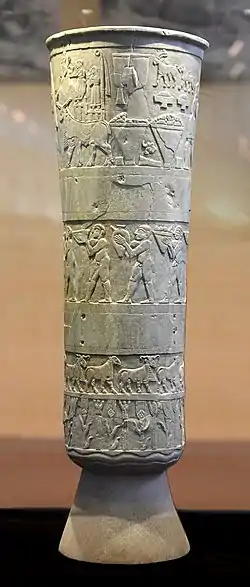 The original Warka Vase, in the National Museum of Iraq. It is one of the earliest surviving works of narrative relief sculpture, dated to c. 3200–3000 BC.