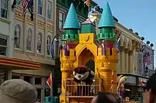 Taz and Honey Bunny from Looney Tunes ride a colourful castle-themed float during the daily parade.