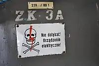 Skull and crossbones sign mounted on a power box in Poland