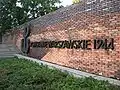 On the wall next to the Warsaw Uprising Monument in Krasiński Square