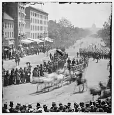 Infantry unit with fixed bayonets followed by ambulances passing on Pennsylvania near the Treasury