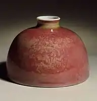 The related copper oxide peach-bloom glaze on a Kangxi water pot, also with incised decoration.