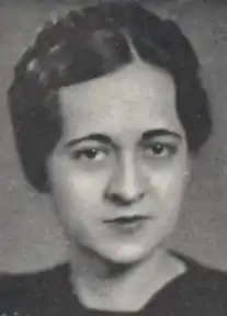 A young woman with dark eyes and dark hair braided across the crown