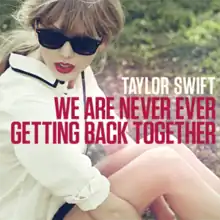 Cover artwork of "We Are Never Ever Getting Back Together", showing Taylor Swift in sunglasses sitting on a grass field