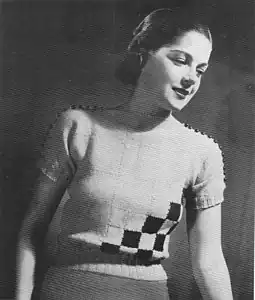 A shoulder-buttoned sweater, made with full-sized and quartered-sized squares (1936 pattern). Knit waist and cuffs.