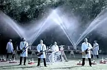 Weezer plays in the foreground while Fritz Grobe and Stephan Voltz set off Diet Coke and Mentos eruptions behind them in the "Pork and Beans" music video. Three members of the band are playing guitar while the other (Pat Wilson) is playing the drums. They are all wearing white tops and black pants.