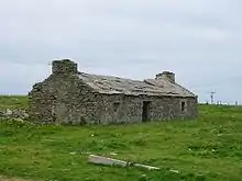 A ruined house on Westray with traditional flag-stone roof
