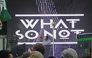 What So Not performing at the stage of the North Coast Music Festival, with his artist name displayed on the front screen.