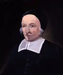 A painting of a man with a white moustache and small beard. He is wearing a skull cap and the bib of a colonial-era minister.
