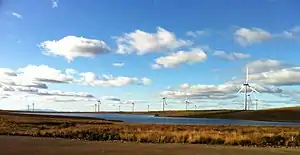 Whitelee Wind Farm with the Isle of Arran in the background.
