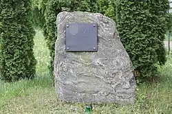 A plaque commemorating 500 years of the village of Wilczogęby on a roadside stone