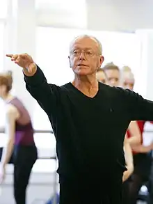 Burmann, standing in a ballet position with an outstretched arm