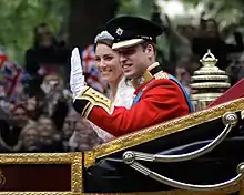 Prince William and Catherine Middleton waving in a carriage during their wedding