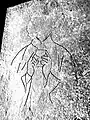 Enhanced outline of figure incised on slab, showing chalice held to the chest and clerical vestments.